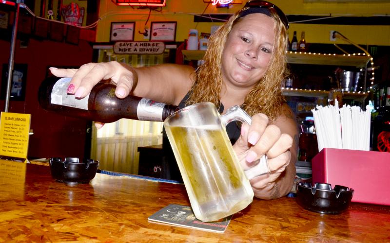 April Rhoden pours a cold one at R Bar on Wednesday afternoon. Since Friday, the bar — along with others in Lake City and throughout the state — has been allowed to serve beer again. (CARL MCKINNEY/Lake City Reporter)