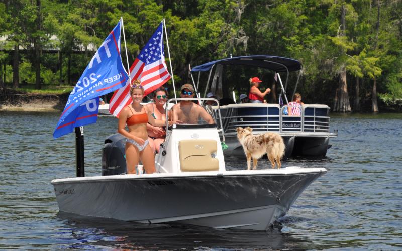 Trump supporters Cayden Taylor, Jarrod Taylor, Heather Spahalski and Paisley the dog participate in a river rally for the president Sunday. Boat rallies are a new fad dubbed the “Trumptilla.” (JEN STRICKLAND WILLIAMSON/Special to the Reporter)