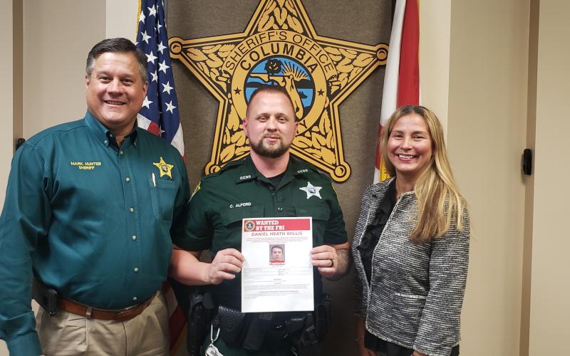 From left are Sheriff Mark Hunter, Deputy Chris Alford and Jacksonville FBI Special Agent In Charge Rachel Rojas. (COURTESY CCSO)