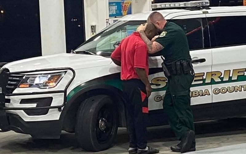 Deputy Chris Alford comforts a young man after an encounter with racists at a local store. (COURTESY CCSO)