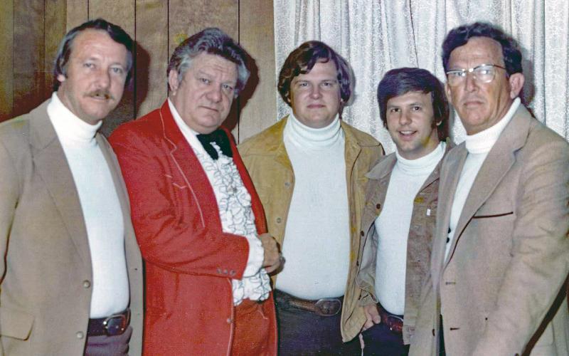 Donald Johns, second from right, meets comedian Jerry Clower during a 1977 performance in Lake City. Donald was at the time part of his cousin’s band, Skip Johns and the Travelers. Skip Johns is pictured at center. (COURTESY)