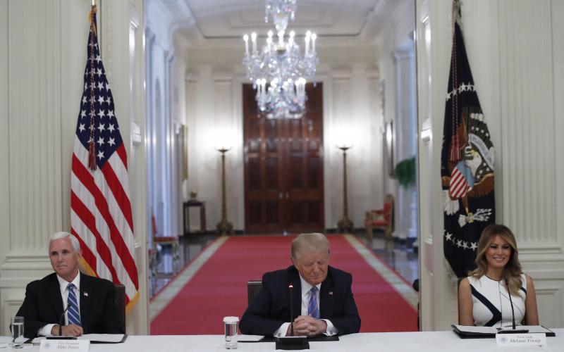 President Donald Trump, Vice President Mike Pence, left, and first lady Melania Trump, attend a “National Dialogue on Safely Reopening America’s Schools,” event in the East Room of the White House, Tuesday in Washington. The conversation continues on the state level as well. (ALEX BRANDON/AP)