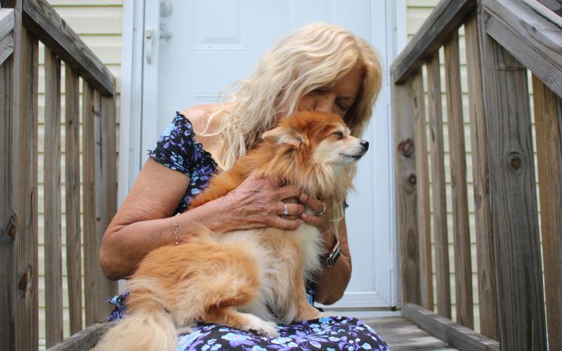 Brenda Brickel, a local registered nurse, holds Teddy Weddy Bear, her eight-pound Pomeranian that woke her Tuesday night when she feel asleep while cooking chicken wings. Brickel credits the dog with saving her life. (TONY BRITT/Lake City Reporter)