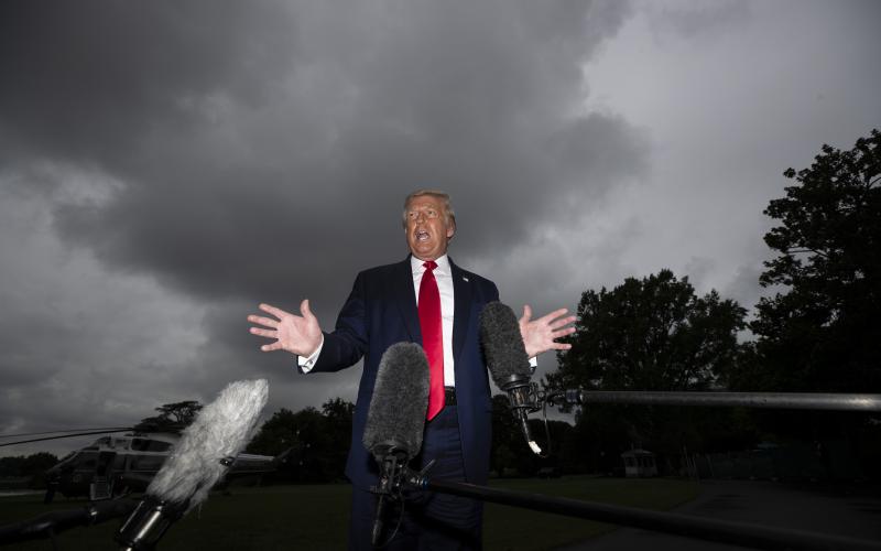 President Donald Trump speaks with reporters before walking to Marine One on the South Lawn of the White House on Friday in Washington. Trump is en route to Florida. (ALEX BRANDON/Associated Press)