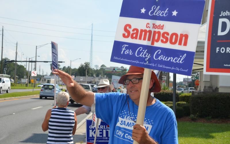 Todd Sampson, waving to traffic along Duval Street on Tuesday afternoon, is headed to a runoff election for the City Council District 13 seat. (CARL MCKINNEY/Lake City Reporter)
