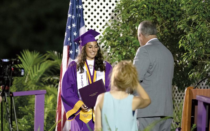 Columbia High’s co-valedictorian Eliana Duarte receives her diploma Saturday during commencement. (RAY CARPENTER/Lake City Reporter)