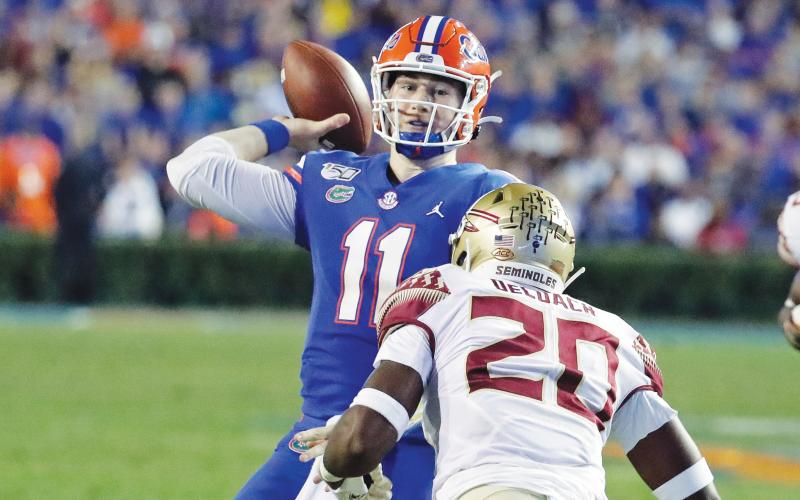 Florida quarterback Kyle Trask (11) throws a pass over Florida State linebacker Kalen DeLoach (20) during the first half of last year's game in Gainesville. (AP FILE PHOTO)