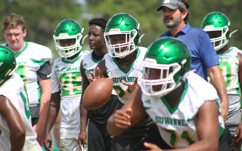 Suwannee quarterback Malachi Graham eyes the snap during drills in practice Tuesday. The Bulldogs began fall practice Monday, the first day allowed by the FHSAA. (JAMIE WACHTER/Lake City Reporter)
