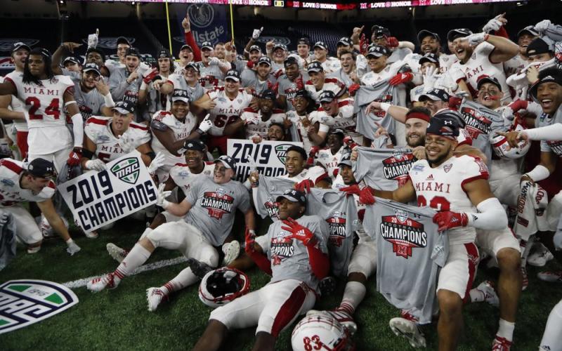 Members of the Miami of Ohio team pose on the field after winning the Mid-American Conference championship against Central Michigan on Dec. 7, 2019, in Detroit. The Mid-American Conference on Saturday became the first league competing at college football’s highest level to cancel its fall season because of covid-19 concerns. (AP FILE PHOTO)