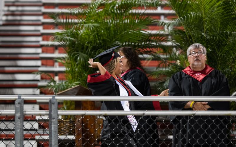 A Fort White senior is excited to receive her diploma during the commencement ceremony. (RAY CARPENTER/Lake City Reporter)
