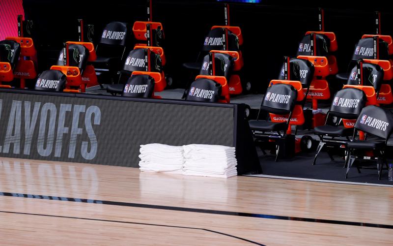 Benches sit empty at game time of a scheduled game between the Milwaukee Bucks and the Orlando Magic for Game 5 of the Eastern Conference first round series at AdventHealth Arena at ESPN Wide World Of Sports Complex on Wednesday, in Lake Buena Vista. (KEVIN C. COX/Getty Images/TNS)