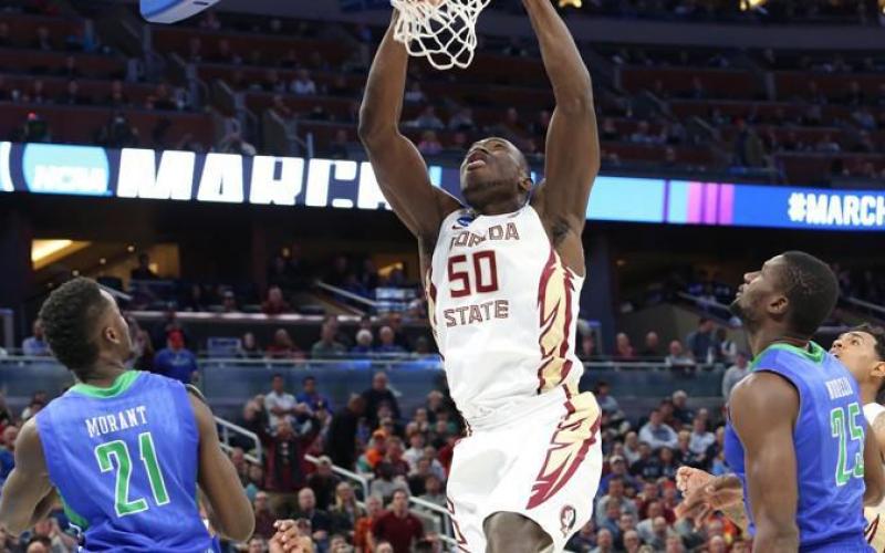 Florida State's Michael Ojo (50) dunks over Florida Gulf Coast's Demetris Morant (21) and Marc-Eddy Norelia (25) during the first round of the NCAA Tournament at the Amway Center on March 16, 2017 in Orlando. (Stephen M. Dowell/Orlando Sentinel/TNS)