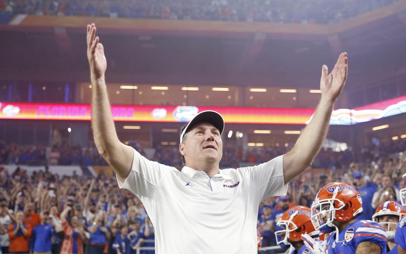 Florida head coach Dan Mullen pumps up the crowd prior to the start of the Capital One Orange Bowl against Virginia at Hard Rock Stadium last December. (MICHAEL REAVES/Getty Images/TNS)