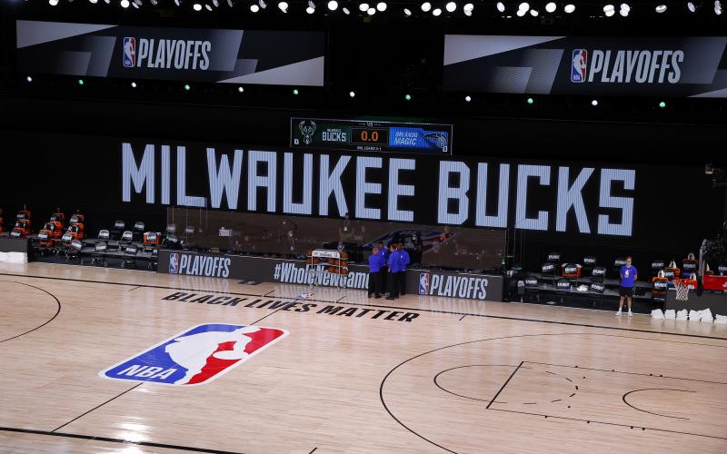 Referees huddle on an empty court at game time of a scheduled game between the Milwaukee Bucks and the Orlando Magic for Game 5 of the Eastern Conference first round series atAdventHealth Arena at ESPN Wide World Of Sports Complex on Wednesday, in Lake Buena Vista. The Bucks boycotted the game to protest the police shooting of Jacob Black. (KEVIN C. COX/Getty Images/TNS)