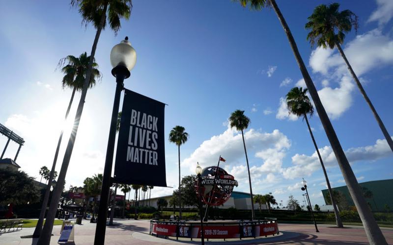 A Black Lives Matter banner hangs outside of the arena after a postponed NBA first round playoff game between the Milwaukee Bucks and the Orlando Magic at AdventHealth Arena at ESPN Wide World Of Sports Complex on Aug. 26, in Lake Buena Vista. (ASHLEY LANDIS/Getty Images/TNS)