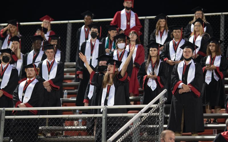 A Fort White student reacts in the bleachers during Friday night’s graduation ceremony. (RAY CARPENTER/Lake City Reporter)
