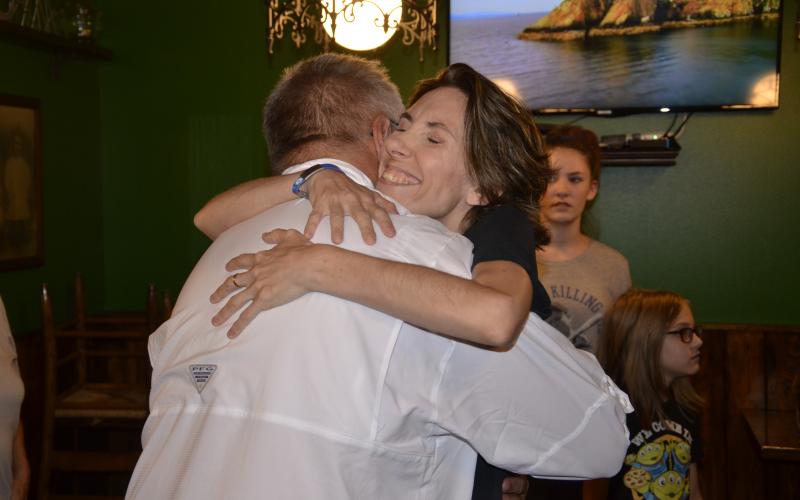 Dawn Wilkerson hugs John Albury on Monday when they met for lunch at Daddy O’Brien’s. Albury, a parademic, rushed to Wilkerson’s aid during an epileptic seizure at the restaurant in July. (CARL MCKINNEY/Lake City Reporter)
