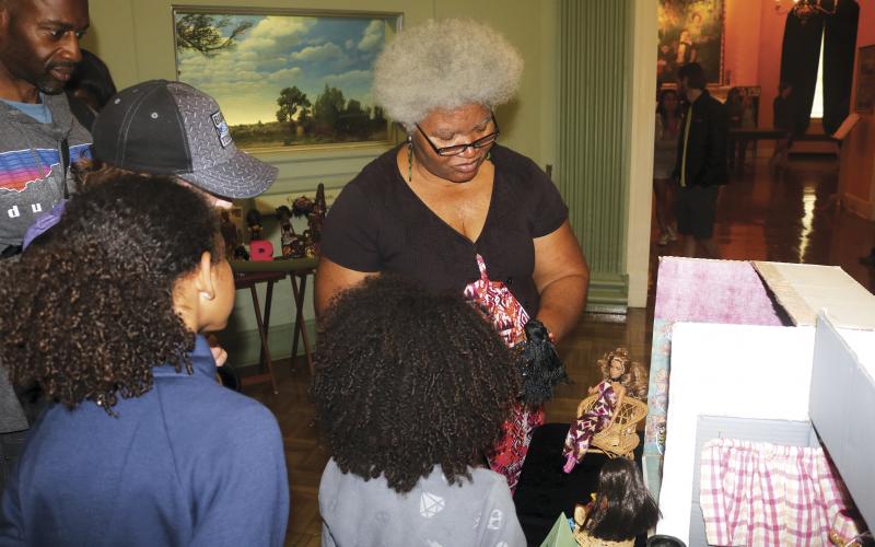 Shirley Marshall talks about her doll collection with guests during a diorama at the Stephen Foster Folk Culture Center State Park. Marshall owns more than 600 dolls, including more than 300 black dolls. (FILE)