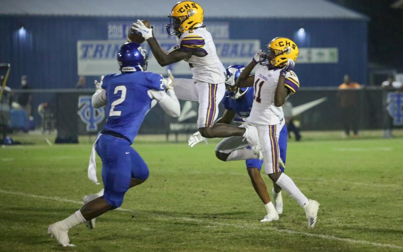 Columbia wide receiver Jaden Williams hauls in a pass in front of Trinity Christian defensive back Christian Ellis on Friday night. (BRENT KUYKENDALL/Lake City Reporter)