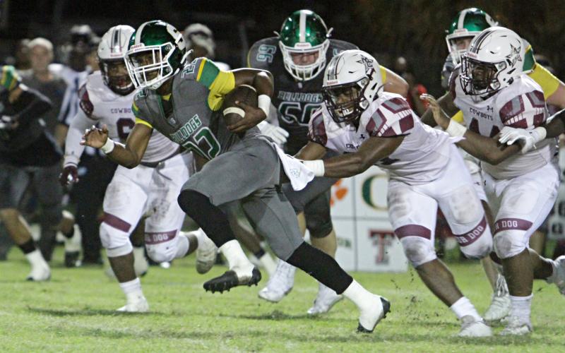 Suwannee running back Malachi Graham tries to pull away from a Madison County defender Friday night at Langford Stadium. (PAUL BUCHANAN/Special to the Reporter)