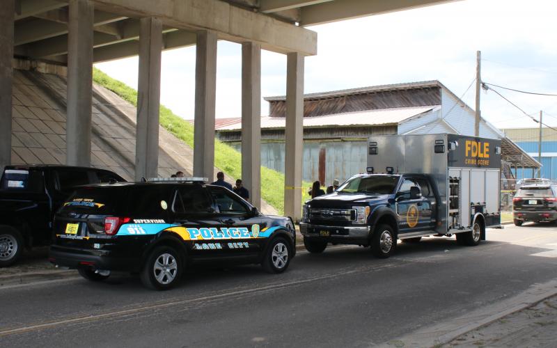 The Florida Department of Law Enforcement’s crime scene technicians helped process the scene on Northwest Railroad Street where a black female body was found Friday morning. (TONY BRITT/Lake City Reporter)