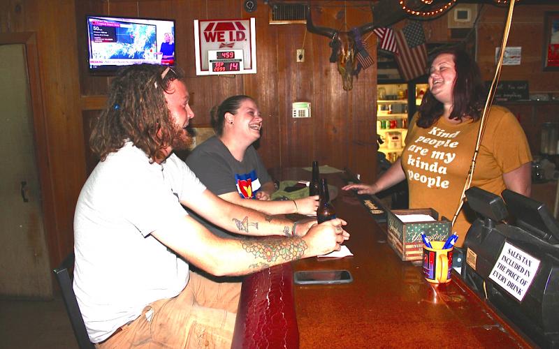 Bar patrons Justin Hudec (left) and Kristin Russell, both of Lake City, share a laugh with Anita Irwin, shortly after the Longbranch Saloon opened Monday afternoon. Hudec and Russell, who were the first customers in the bar Monday, said they also were in the Longbranch on St. Patrick’s Day when the first shutdown order came through. (TODD WILSON/Lake City Reporter)