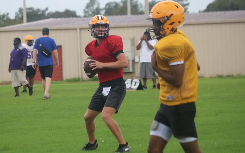 Columbia quarterback Kade Jackson drops back to pass during practice on Monday. Jackson is competing for the starting quarterback position with Ty Wehinger. (JORDAN KROEGER/Lake City Reporter)