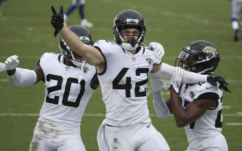 Jacksonville Jaguars safety Andrew Wingard (42) celebrates after intercepting a Indianapolis Colts pass with teammates safety Daniel Thomas (20) and Chris Chaisson, right, on Sunday, in Jacksonville. (STEPHEN B. MORTON/Associated Press))