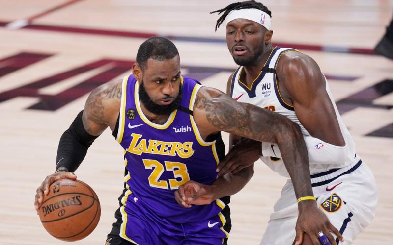 Los Angeles Lakers' LeBron James (23) drives against Denver Nuggets' Jerami Grant during Game 5 of the Western Conference finals on Saturday, in Lake Buena Vista. (MARK J. TERRILL/Associated Press)