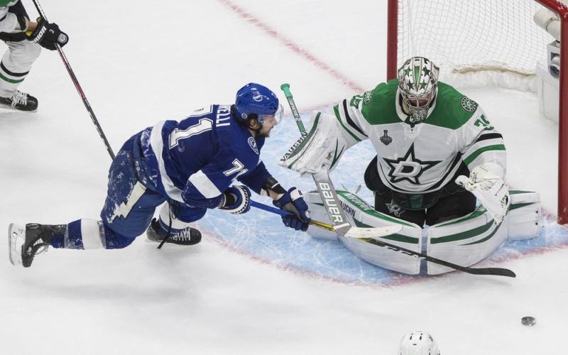 Tampa Bay Lightning center Anthony Cirelli (71) can't get to the puck as Dallas Stars goaltender Anton Khudobin (35) covers the net during the first overtime in Game 5 of the NHL hockey Stanley Cup Final on Saturday, in Edmonton, Alberta. (JASON FRANSON/The Canadian Press via AP)
