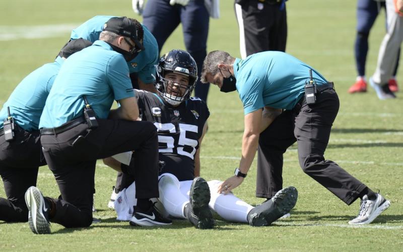 Jacksonville Jaguars center Brandon Linder (65) is helped by medial personnel after being injured against the Tennessee Titans on Sunday, in Nashville, Tenn. (MARK ZALESKI/AP Photo)