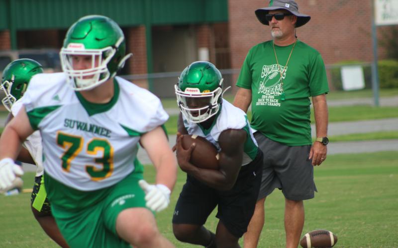 Suwannee quarterback Jaquez Moore follows a block during practice in August. (FILE)