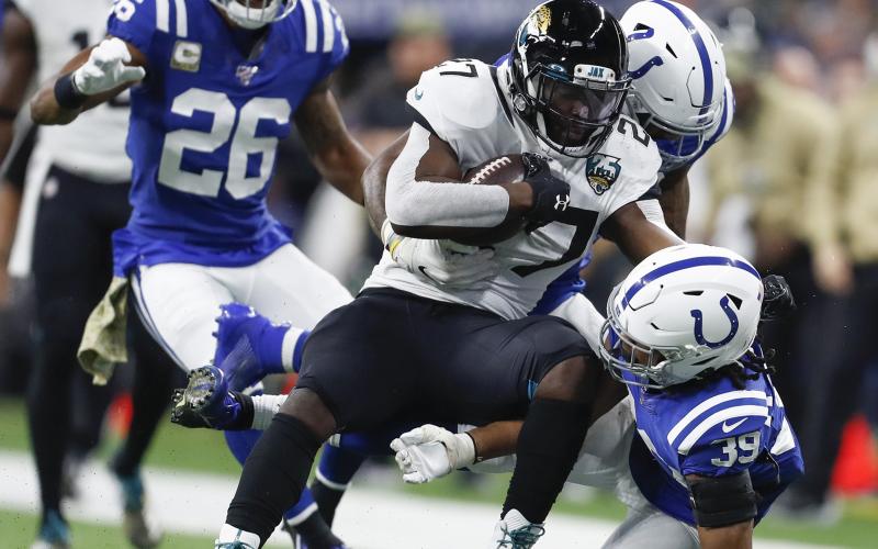 Jacksonville Jaguars running back Leonard Fournette (27) is surrounded by Indianapolis Colts defenders on this second half run at Lucas Oil Stadium on Nov. 17, 2019,  in Indianapolis, Ind. Fournette was released by the Jaguars on Monday and went unclaimed on waivers Tuesday. (SAM RICHE/TNS)