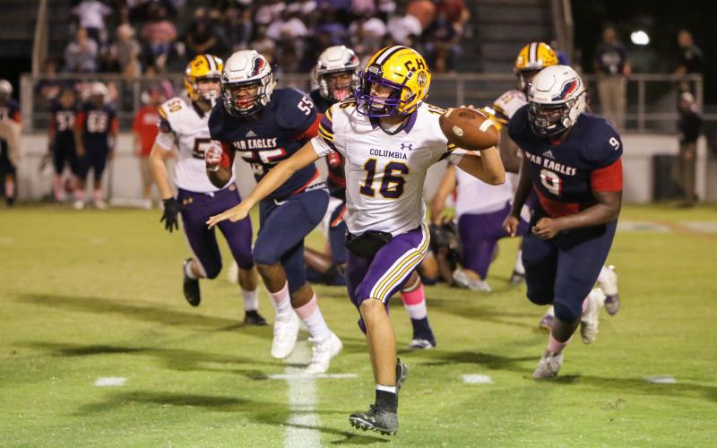 Columbia quarterback Bronsen Tillotson rolls out to pass against Wakulla on Friday night. (BRENT KUYKENDALL/Lake City Reporter)