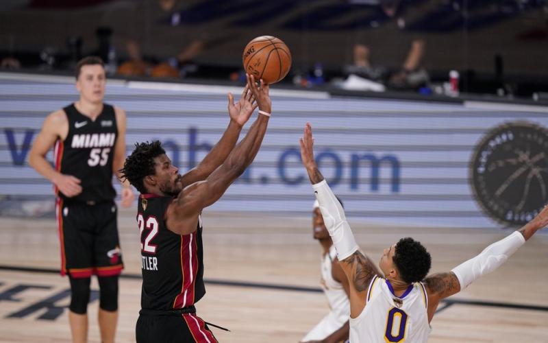 Miami Heat's Jimmy Butler (22) shoots against Los Angeles Lakers' Kyle Kuzma (0) during the second half in Game 3 the NBA Finals on Sunday, in Lake Buena Vista. (MARK  J. TERRILL/Associated Press)
