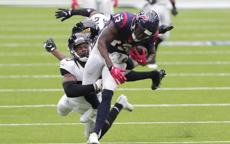 Houston Texans wide receiver Brandin Cooks (13) is hit by Jacksonville Jaguars safety Daniel Thomas (20) after a catch Sunday in Houston. (MICHAEL WYKE/Associated Press))