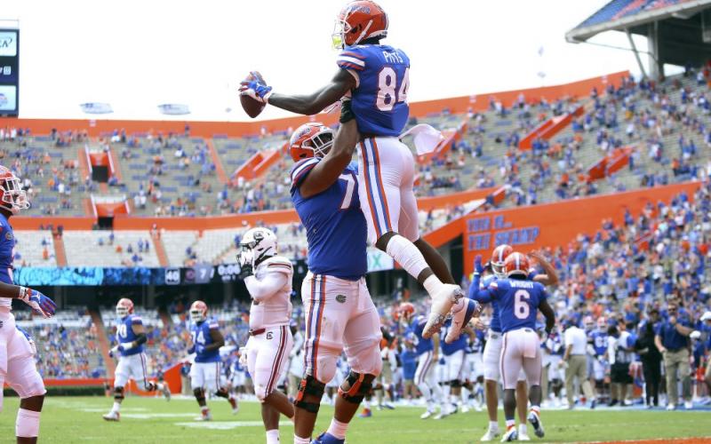 Florida tight end Kyle Pits (84) leaps up as he celebrates a touchdown catch with teammates against South Carolina on Saturday, in Gainesville. (BEAD MCCLENNY/The Gainesville Sun via AP, Pool)