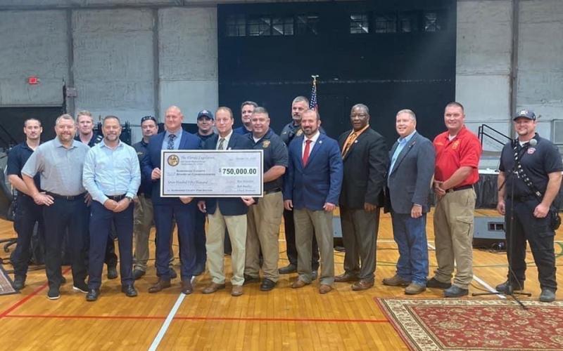 Suwannee County officials with state legislators Chuck Brannan and Rob Bradley after receiving a check for $750,000 in state appropriations for a new fire station. (COURTESY Suwannee County Fire Rescue)