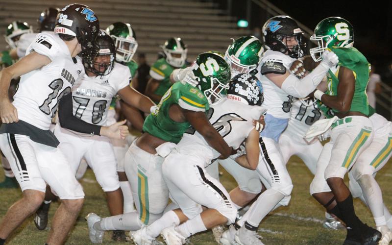 Suwannee defensive lineman Garris Reed, left, and linebacker Blaine Howard wrap up Ponte Vedra running back Campbell Parker on Friday night. (PAUL BUCHANAN/Special to the Reporter)