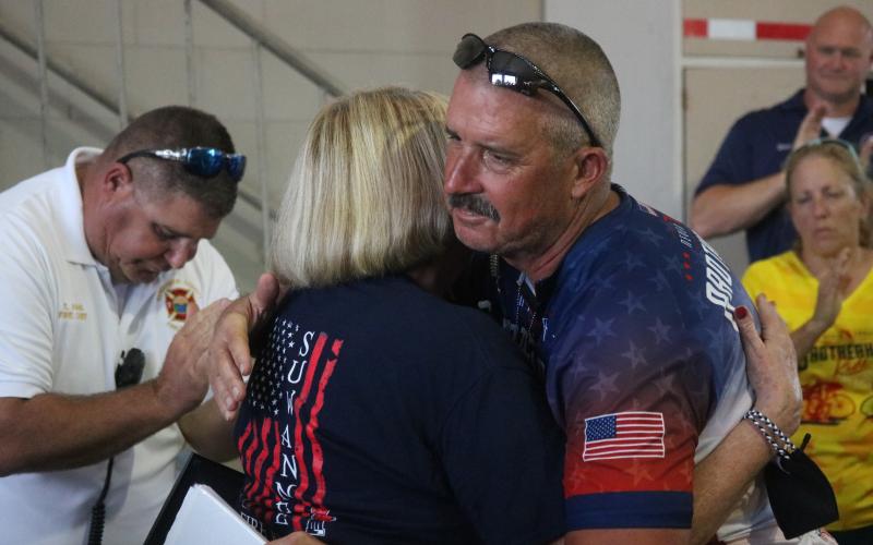 Sharon Sommers, James Sommers’ mother, hugs Jeff Morse, the found of the Brotherhood Ride, after the group honored James Sommers on Wednesday. (JAMIE WACHTER/Lake City Reporter)