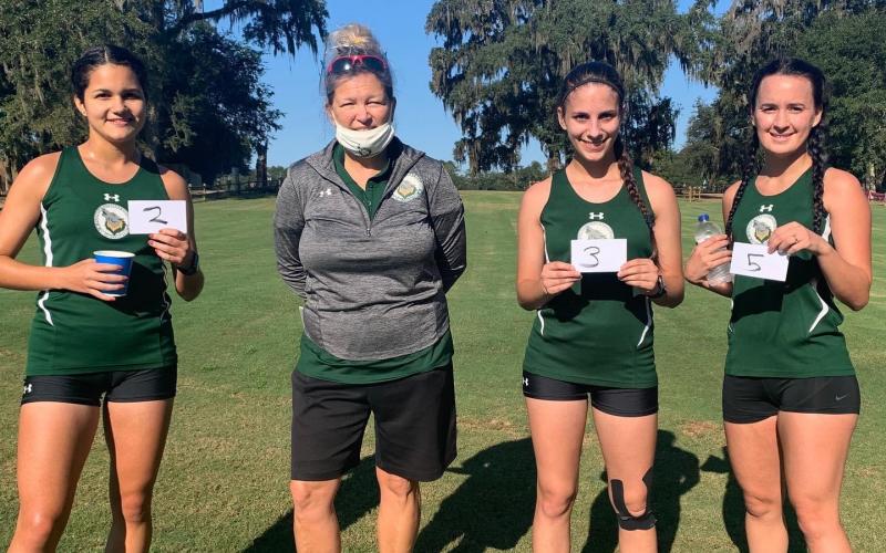 Merlin Leal (second place), Savana Thomas (third) and Amber Hollingsworth (fifth) all placed in the top five at the Tallahassee Community College Open on Saturday. Pictured are Leal (from left), FGC coach April Morse, Thomas and Hollingsworth. (COURTESY)