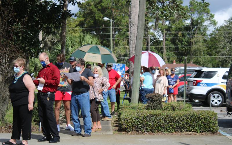 Voters wait in line outside the Columbia County Supervisor of Elections Office Thursday during the first day of early voting. More than 1,700 local voters cast ballots during the first day of early voting. (TONY BRITT/Lake City Reporter)