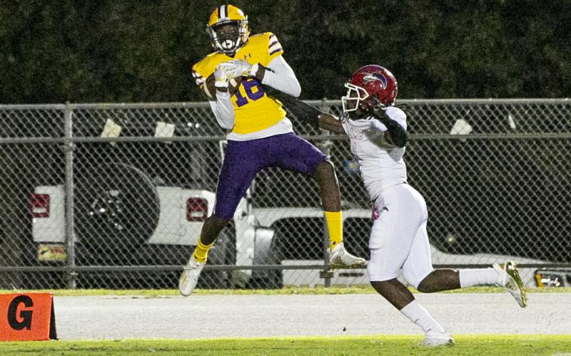 Columbia receiver Marcus Peterson catches a touchdown pass against North Miami Beach in the first quarter Friday night. Peterson also threw three touchdown passes in the fourth quarter to lead the Tigers to a come-from-behind victory. (JEN CHASTEEN/Special to the Reporter)