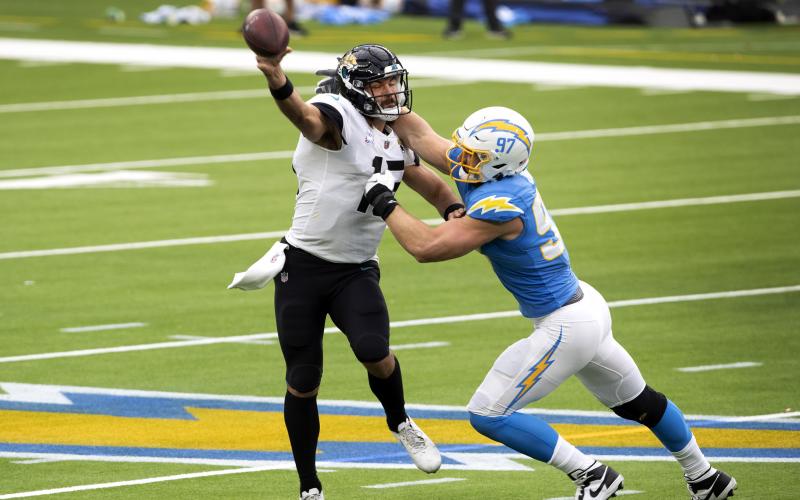 Jacksonville Jaguars quarterback Gardner Minshew II throws under pressure from Los Angeles Chargers defensive end Joey Bosa, right, in the first half at SoFi Stadium on Oct. 25 in Inglewood, California. The Chargers won, 39-29. (ALLEN J. SCHABEN/Los Angeles Times/TNS)