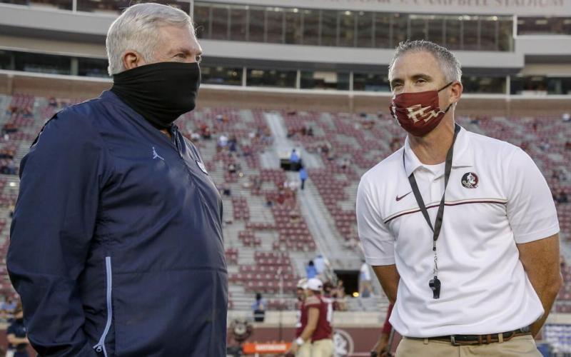 North Carolina coach Mack Brown, left, visits with Florida State coach Mike Norvell before the start of last weekend's game won by the Seminoles. (ACC POOL PHOTO)