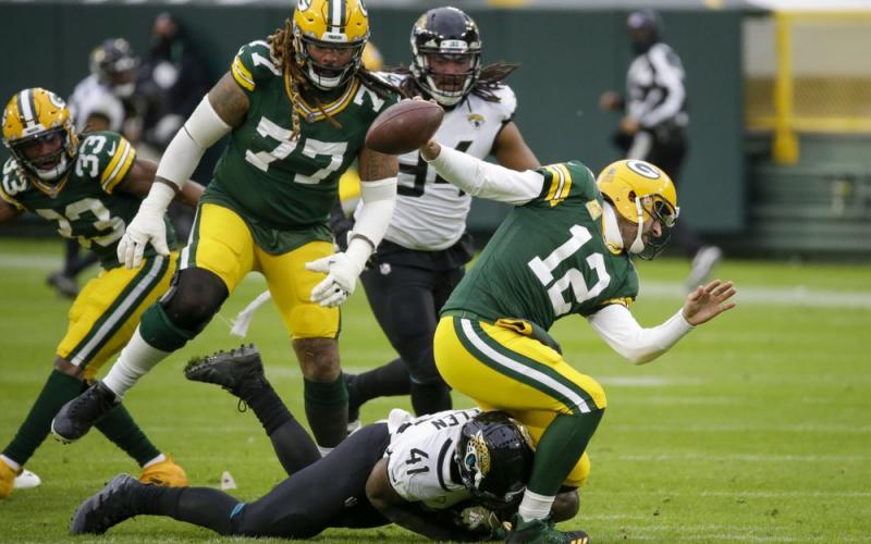 Jacksonville Jaguars' Josh Allen takes down Green Bay Packers' Aaron Rodgers on Sunday in Green Bay, Wis. Roughing the passer was called on the play. (MIKE ROEMER/Associated Press)
