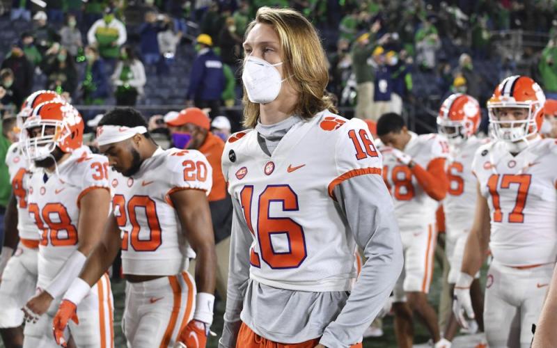 Clemson quarterback Trevor Lawrence (16) leaves the field with his teammates after Clemson lost to Notre Dame 47-40 in two overtimes on Nov. 7 in South Bend, Ind. As virus disruptions mount and the Dec. 19 end of college football's regular season draws closer, the possibility grows that conference championships, major awards and even College Football Playoff participants will be determined by covid-19. (MATT CASHORE/AP Pool File Photo)