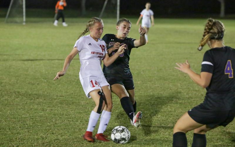 Columbia’s Isa Maranto fights for possession of the ball with Keystone Heights’ Lindsay Hovsepian on Monday night. (BRENT KUYKENDALL/Lake City Reporter)