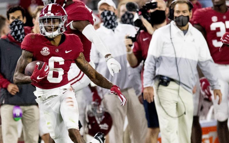 Alabama wide receiver DeVonta Smith (6) heads for a long gain as coach Nick Saban watches during a game against Kentucky on Nov. 21 in Tuscaloosa, Ala. (MICKEY WELSH/The Montgomery Advertiser via AP)