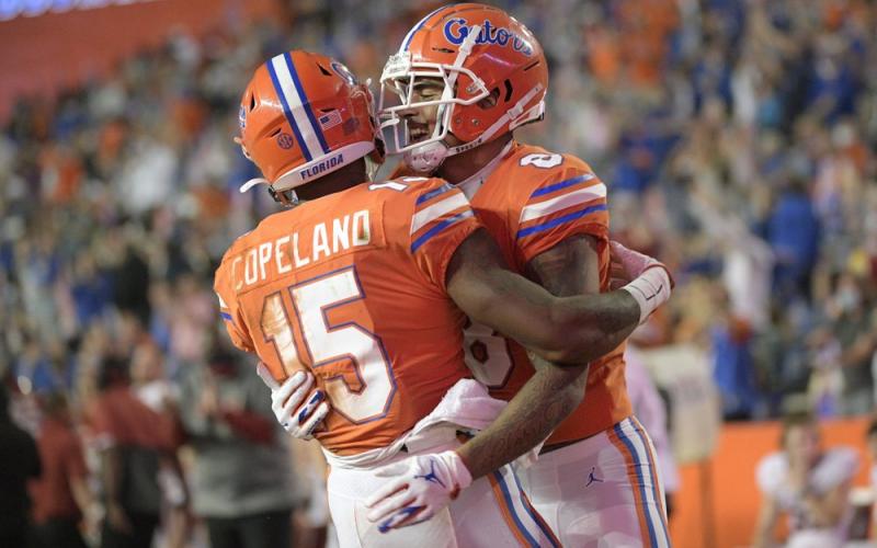 Florida wide receiver Jacob Copeland (15) is congratulated by wide receiver Trevon Grimes (8) after catching a pass for a 33-yard touchdown against Arkansas on Nov. 14 in Gainesville. (PHELAN M. EENHACK/Associated Press)
